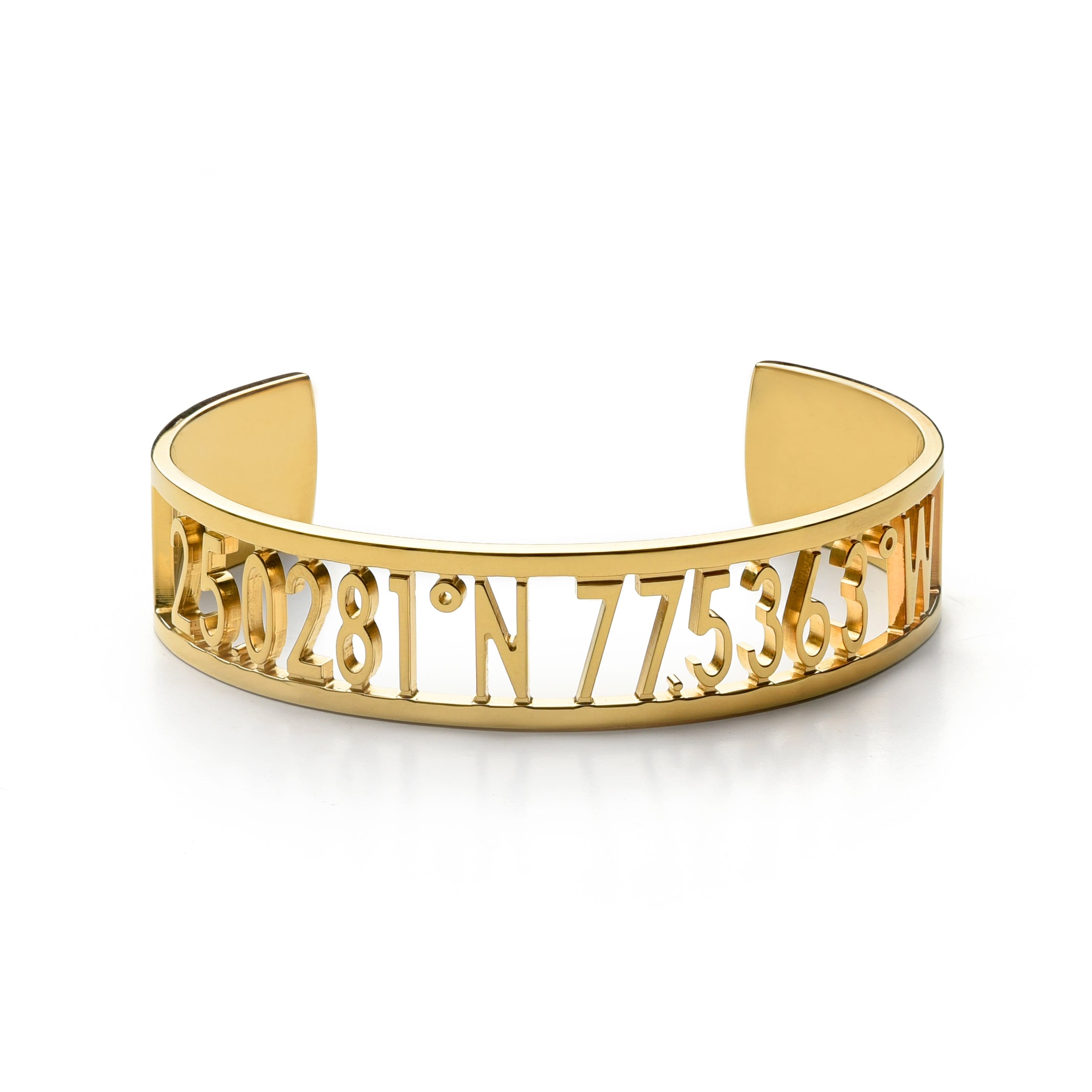 A thick gold cuff bracelet with carved out inscription