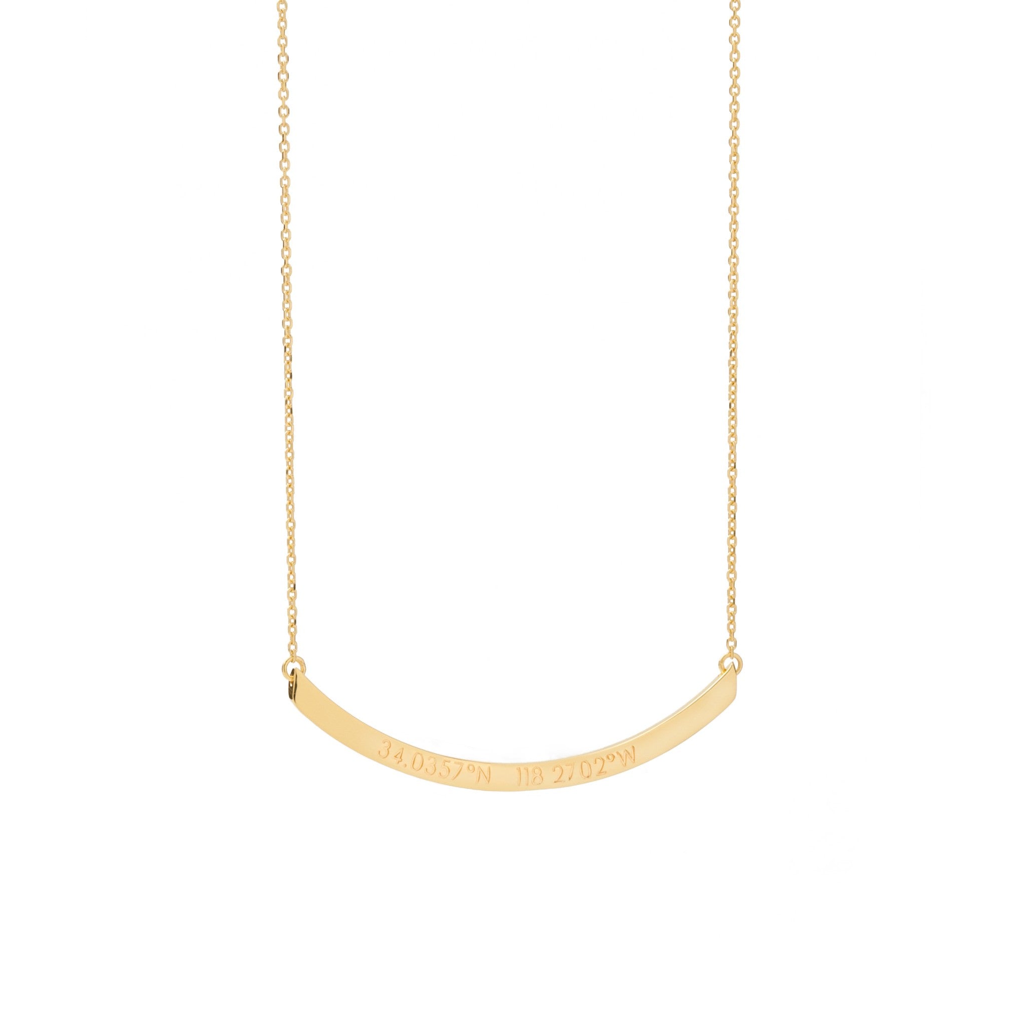 A long gold curved horizontal pendant with inscription on a gold chain