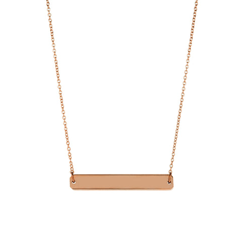 A straight horizontal gold pendant with inscription on a gold chain